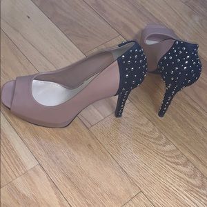 Nude pumps with black suede heel & gold details.